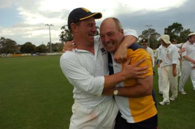 Heath Behrens and Wayne Walsh emabrace after the final wicket.