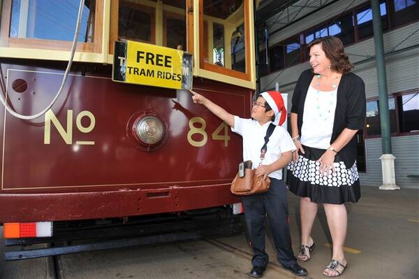all aboard: Junior volunteer conductor Finn Hourigan invites Dianne Holden to take a free tour.