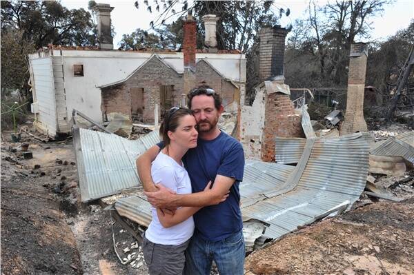 SHATTERED: Bridget and Bill Conroy amid the ruins of their historic family property in Happy Valley Road.