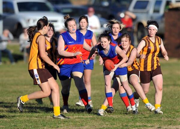 HEAT IS ON: Marong’s Caitlin McKeown is tackled by Huntly’s Emily Bickley as Laura Knight, Catherine Prime, Jane Prime, Jessica Day and Rachel Atkinson move in to gain possession in the clash at Malone Park.          Picture: JULIE HOUGH