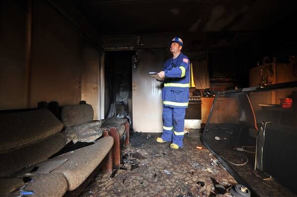 Bendigo CFA operations officer Craig Brittain investigates the scene of a bungalow fire in Kangaroo Flat.