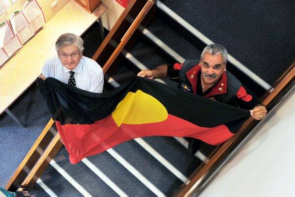 UNITY: Bendigo mayor Alec Sandner holds the Aboriginal flag with Charlie Knight.