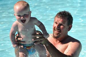 SPLASH: Darren Perry and his son Max discovered the best way to keep cool during the heat was in the water at the Brennan Park Swimming Pool. Picture: JULIE HOUGH
