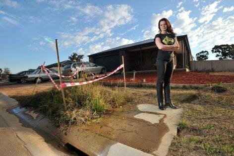 SOAKING: Jo Boyd outside her California Gully home where water has been leaking from the nature strip for some time.  Picture: JIM ALDERSEY