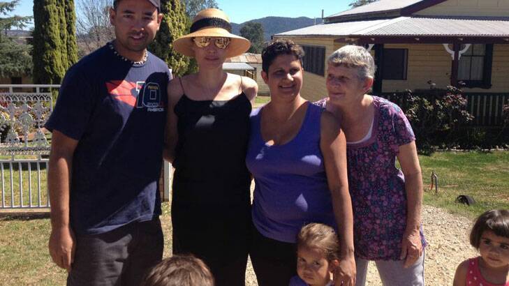 Angelina Jolie poses with locals in Werris Creek. Photo: John Wooderson