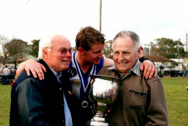 club legend: Allen Marlow (right) with John Forbes and captain Scott Lawry after Mitiamo’s 2009 grand final win.