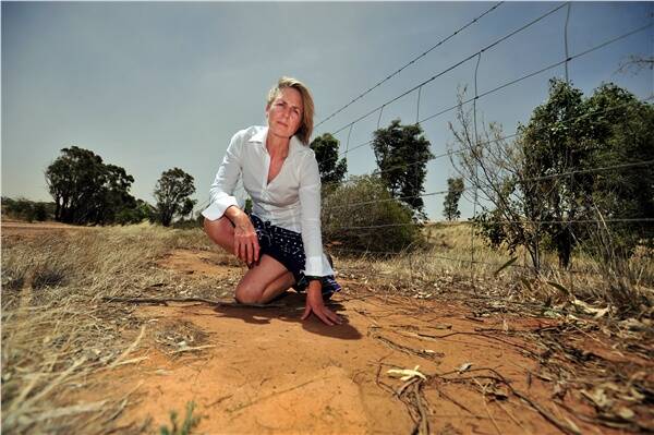 DRY DAMS: Vanessa Richardson examines the affected area.nts affected by rising water tables caused by tailing dams.