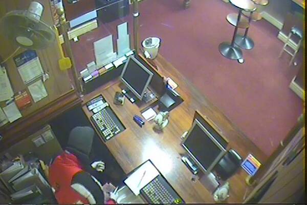 A CCTV image of the armed robbery at the Botanical Gardens Hotel in White Hills.