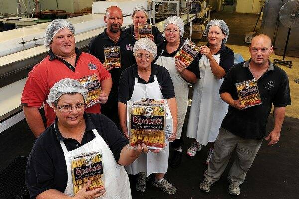 under threat: Kooka’s Country Cookies staff, front from left, Debbie Romeo, Dwain Dempsey and Barb Fox; back, Travis Hickmott, Fay Moloney, Glenda House, Bernie Abbott and Stephen Blake.Picture: Paul Carracher