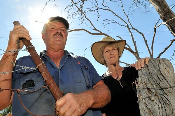 EIGHT-YEAR BATTLE: Max and Pauline Carter defiantly replace a temporary gate.
