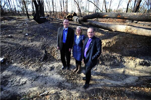 SUPPORT: Father Tony Nobel from San Diego, Chaplain Tracey Wolsley and Bishop Andrew Curnow survey bushfire damage.