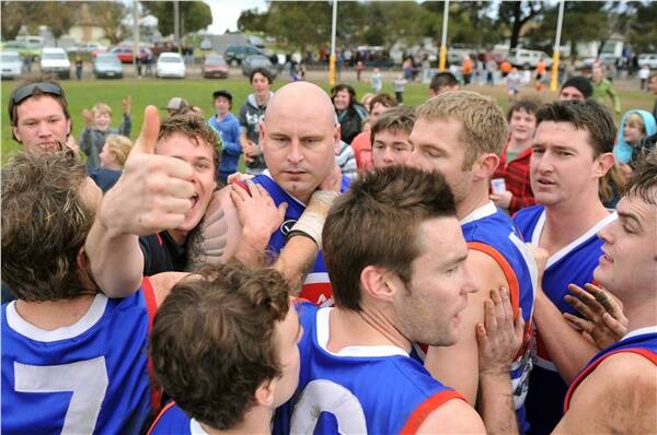 CENTRE OF ATTENTION: Aaron James is surrounded by North Bendigo teammates and fans after reaching the century mark in Saturday's win against LBU. Picture: ALEX ELLINGHAUSEN