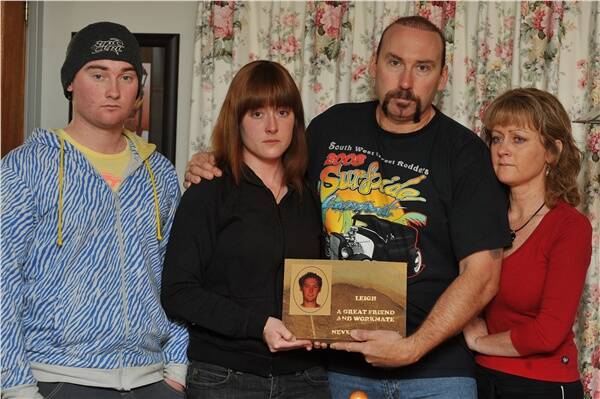 GRIEVING: Billy, Sandy, Leigh senior and Vicki Charter with a tribute plaque to their son and brother, Leigh.