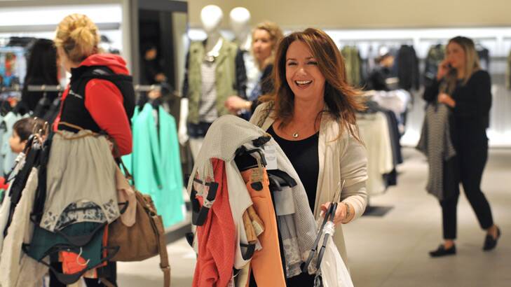 Fil Marninelli grabs an armful of clothes at the Zara Chadstone opening.