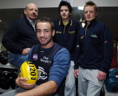 GO BLUES: Carlton’s young gun Andrew Walker with Bendigo Pioneers Football Club regional manager Ray Byrne and talented players Josh Strachan and Ben Gregg in the Bendigo Leisure Centre gym at the Pio