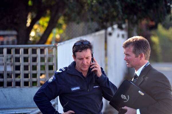 Homicide Squad detectives at the Long Gully house yesterday.