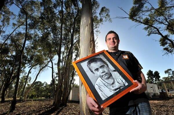 WINNING IMAGE: Indigenous artist Simon Penrose with his photographic portrait of his nephew.  Picture: JIM ALDERSEY