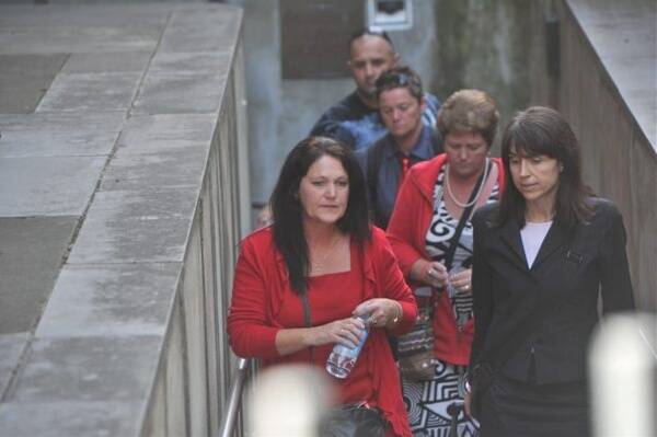 TESTIMONY: Lyn Ireland, left, Jennifer Braddy (back, with red tie), Debra MacDonell and lawyer Mandy Fox outside court this week. Lyn, Jennifer and Debra are all sisters of Maureen Braddy and all gave evidence yesterday. They wore red to the inquest because it was the colour Maureen was wearing the last time she was seen.  Picture: MATT KIMPTON