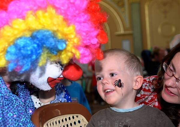 G’DAY: Crackles the Clown makes friends with three-year-old Ethan Harris at the Community Christmas lunch.