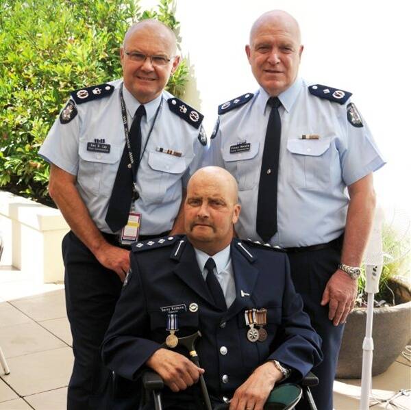 Honoured: Chief Commissioner Ken Lay and Deputy Commissioner Kieran Walshe with decorated Bendigo Inspector Gerry Rudkins at the Epworth Hospital.  Picture: VICTORIA POLICE