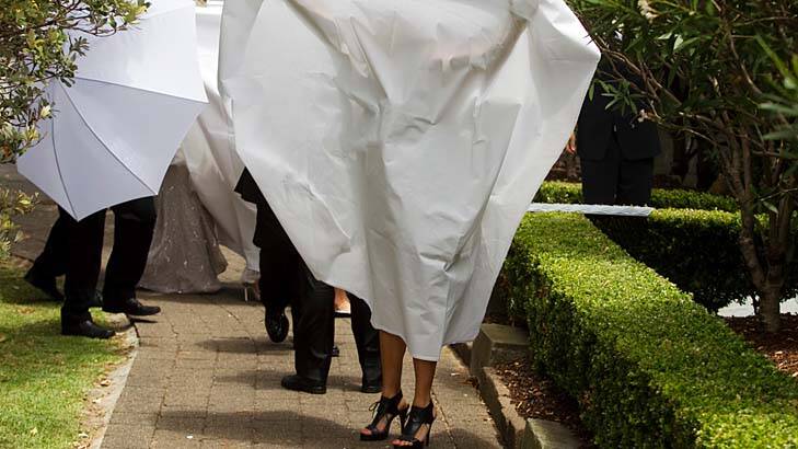 Covert operation ... the bride is shielded.