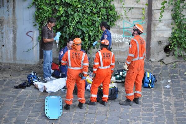 Emergency service crews attend to the man after his fall.