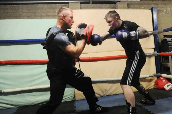 HARD-HITTER: Danny Taggert spars with trainer Frank Pianto. Picture: JULIE HOUGH