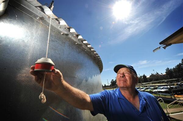 TESTING: Ron Angove checks the water level on the bowls club’s recycled water tank.
