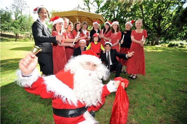 TUNING UP: Santa with COGB’s Leanne Rosewall, Phil Lazenby, Stan Liacos and the Bendigo Youth Choir - carols will be back at the park on December 21.