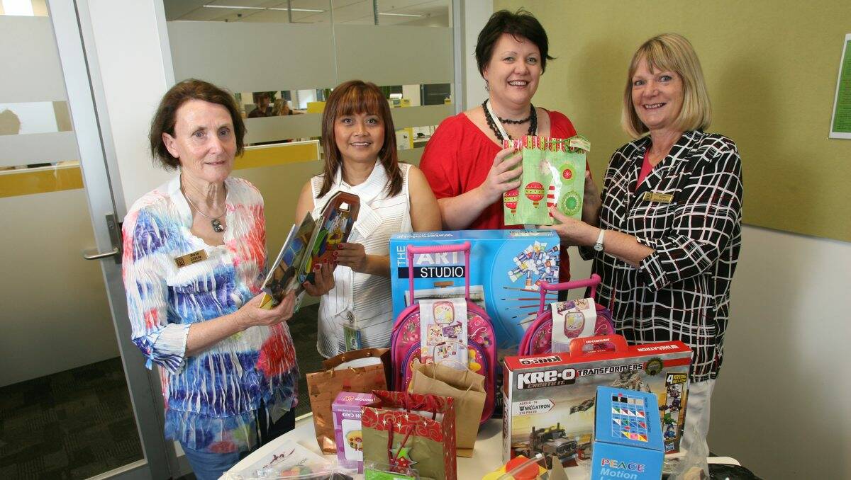 GIVING: Zonta Club of Bendigo member Dale Little, Haven staff Haydee Bell and Megan Richardson, and Zonta president Rosalie Lake with some of the donated Christmas presents. Picture: PETER WEAVING