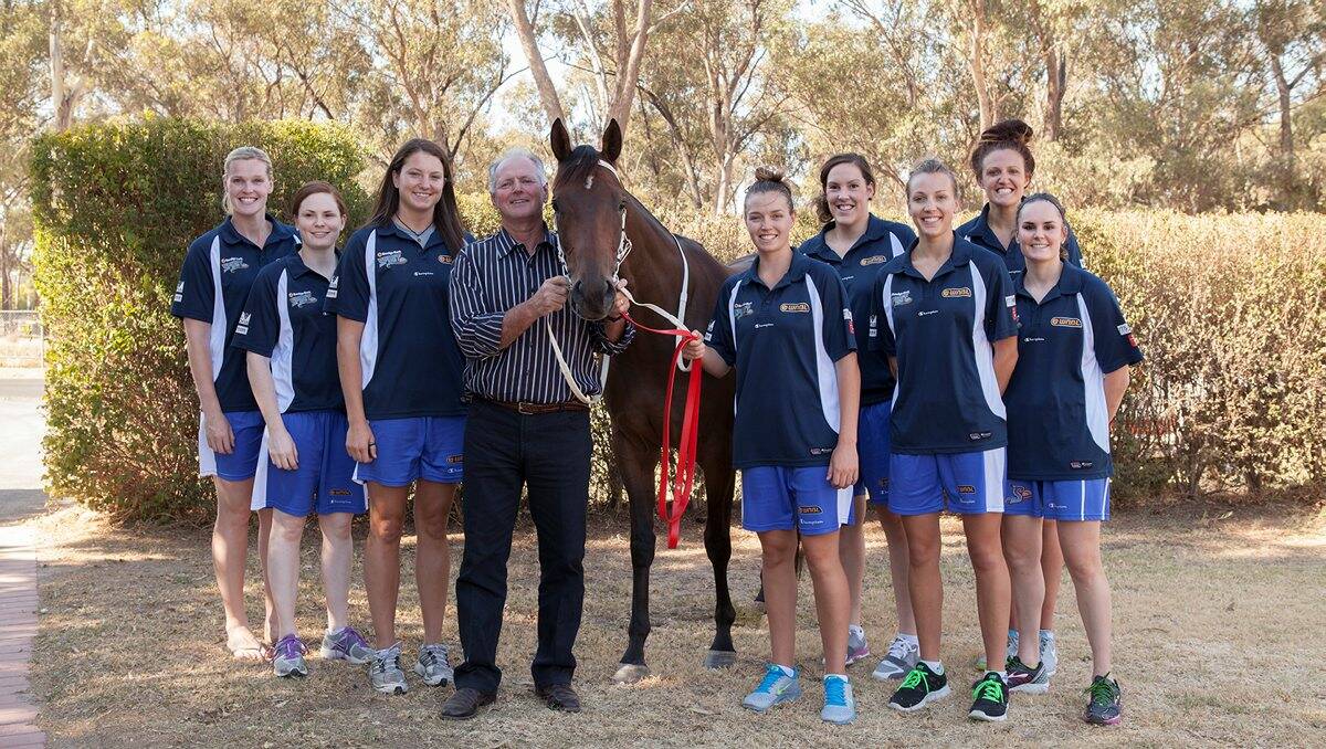 THAT’S THE SPIRIT: Trainer Shaun Dwyer and filly Shy Girl with Spirit players Chelsea Aubry, Andrea Wilson, Kelsey Griffin, Ebony Antonio, Gabe Richards, Maddie Garrick, Rachel Herrick and Kelly Wilson.                                                                                                      Picture: LAUREN HARMER