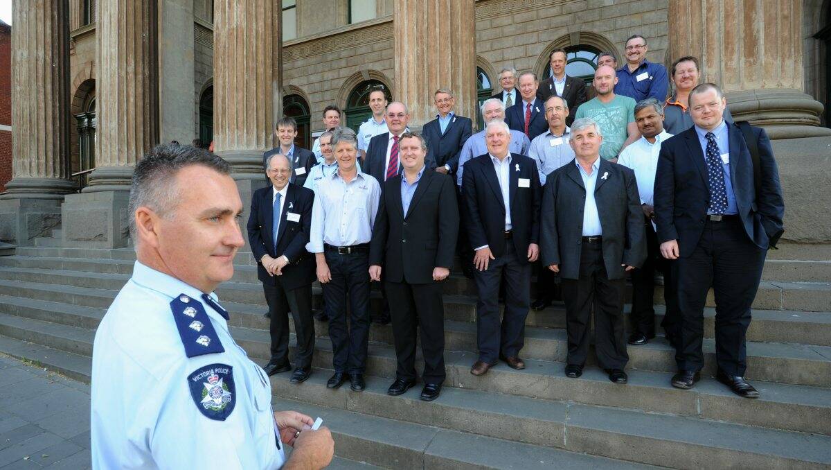 UNITED: Inspector Mark Edwards on the steps of The Capital with the men who attended yesterday’s White Ribbon breakfast. Picture: PETER WEAVING 