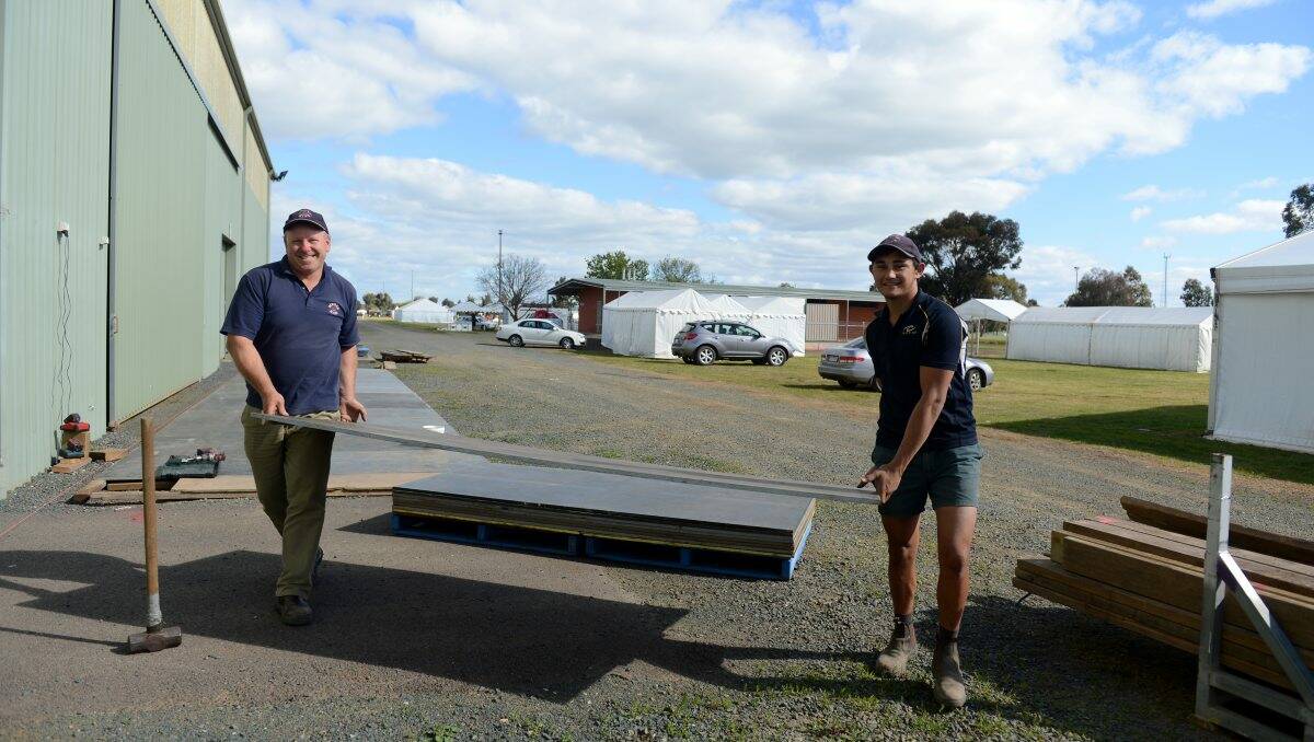Preparing: Chris King and Kieren Andrew from Bourke Hire help set up for the Elmore Field Days.