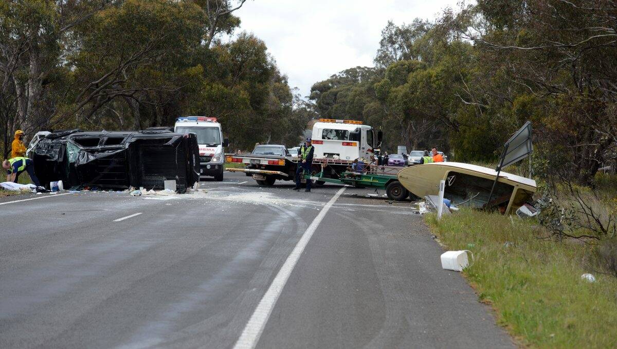 DAMAGE: Two men were lucky to escape with only minor injuries from this 4WD rollover on the Midland Highway. Investigators believe an incorrectly loaded trailer to be the cause of the accident. Picture: Jim Aldersey