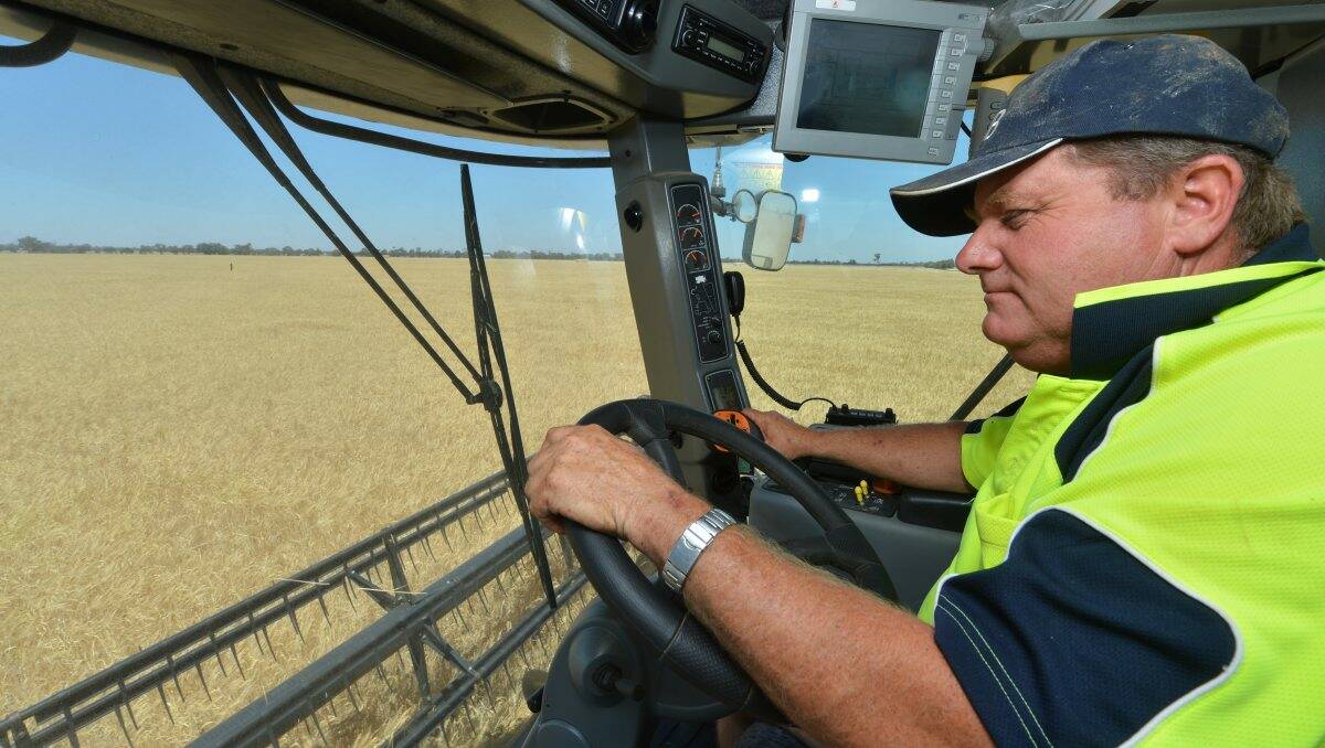 AIR-CONDITIONED: Elmore farmer Phillip Neale harvests barley on his property. Picture: BRENDAN McCARTHY