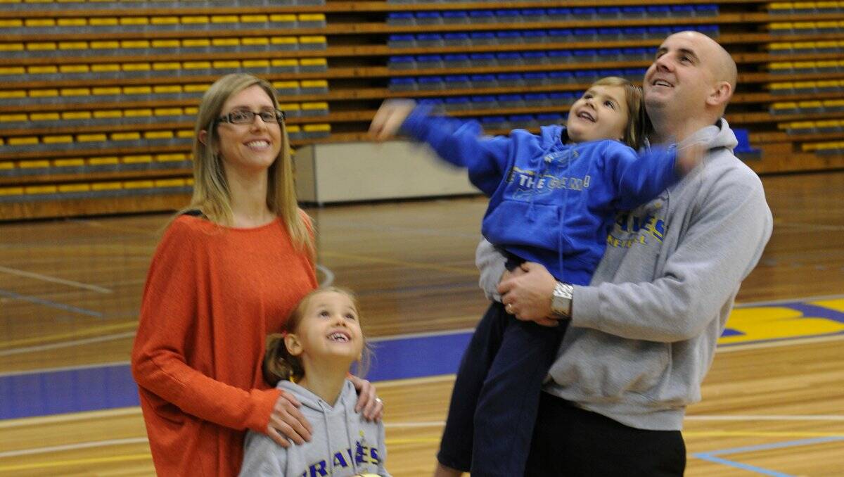 HAVING A BALL: Kirstie, Lily, Mia and Ben Harvey at yesterday's announcement at Bendigo Stadium that he will coach the Bendigo Braves basketball team in 2013. Picture: PETER WEAVING