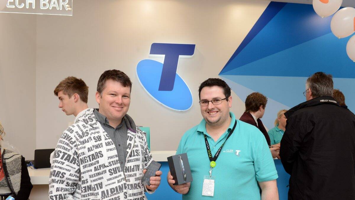 Early bird: Ben Free, left, with Telstra’s Jay Kennedy, was first in line for the release of the iPhone 5 yesterday. Picture: JIM ALDERSEY