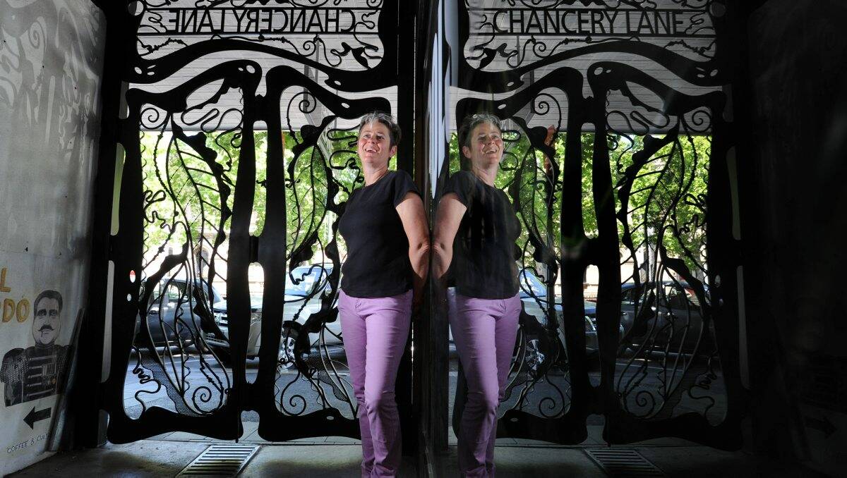 REFLECTING: Sculptor Yvonne George and the gates to Chancery Lane she created. Picture: PETER WEAVING