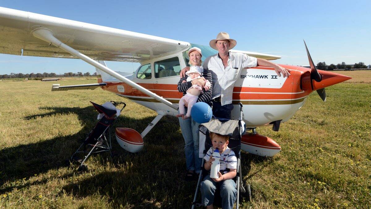 Innovative: Manangatang residents Lee-Anne, holding four-month-old Elise, Peter, and two-year-old Luke Thompson beat the traffic and flew to the final day of the 2012 Elmore Field Days. Pictures: Jim Aldersey
