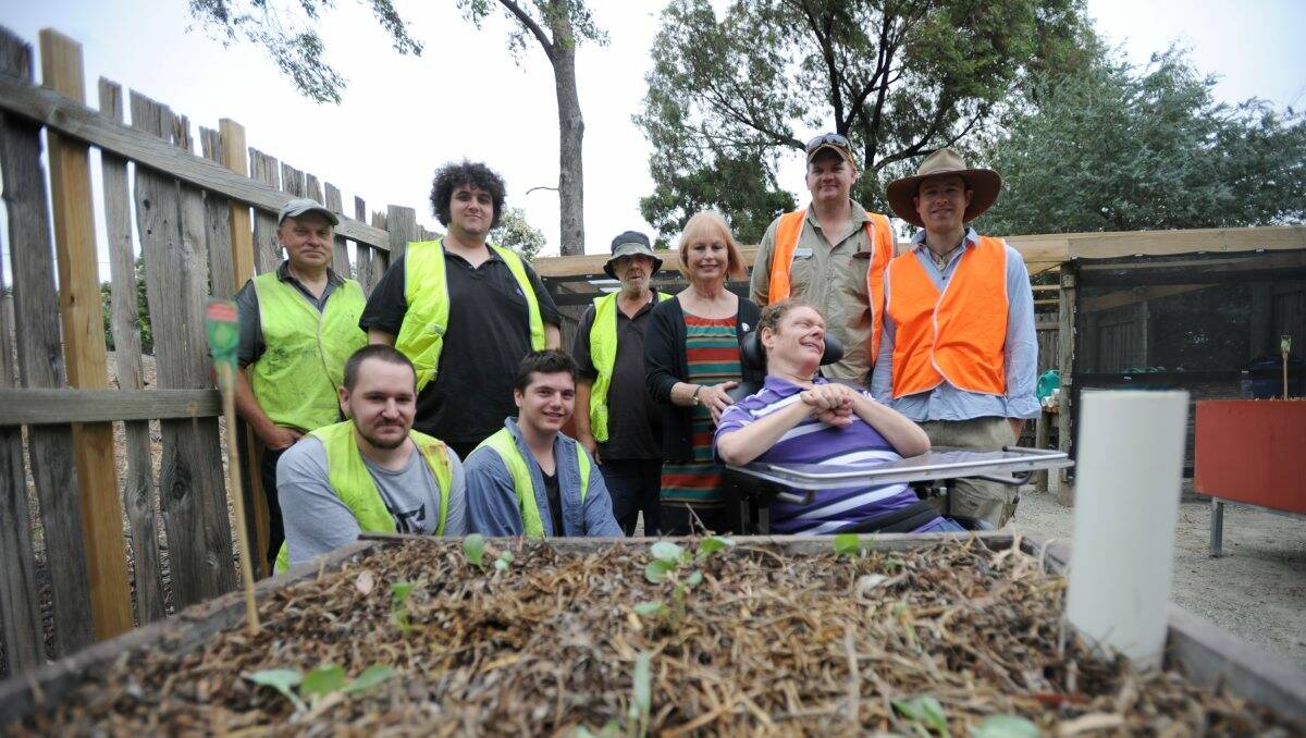 MAKEOVER: Volunteers Ian Piet, Iain Stewart, Alan Gibbons, Brent Tabenor and Harrison Sheehan with Scope Golden North Lifestyle Options co-ordinator Helen Worrell, Scope client Chris Loveless and Conservation Volunteers Australia’s team leaders Charlie Dangerfield and Tim Fraser. Picture: JODIE DONNELLAN  