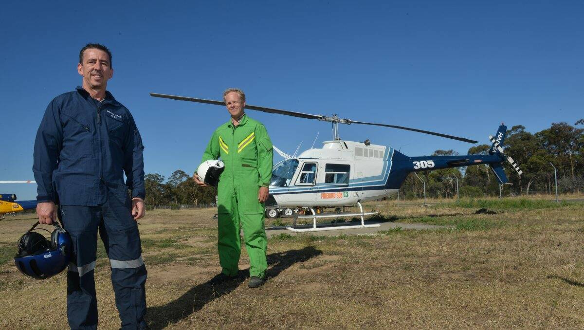 READY:  Pilot Brenton Yorath and AAS Chris Hodder with a Firebird 305 (spotter aircraft). Picture: BRENDAN McCARTHY