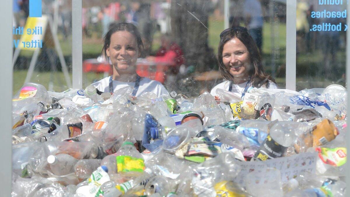 MINDFUL: Kira Eviston and Allyson Osborne from EPA Victoria with a giant box full of litter at Lake Weeroona’s Australia Day ceremony. 