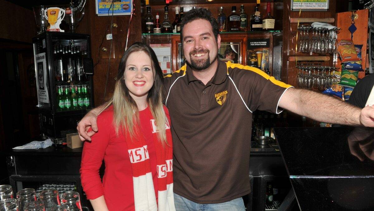 ONE EACH WAY: Pugg Mahones bar staff Aimee Phegan and Rod Garner.  Pictures: JODIE DONNELLAN