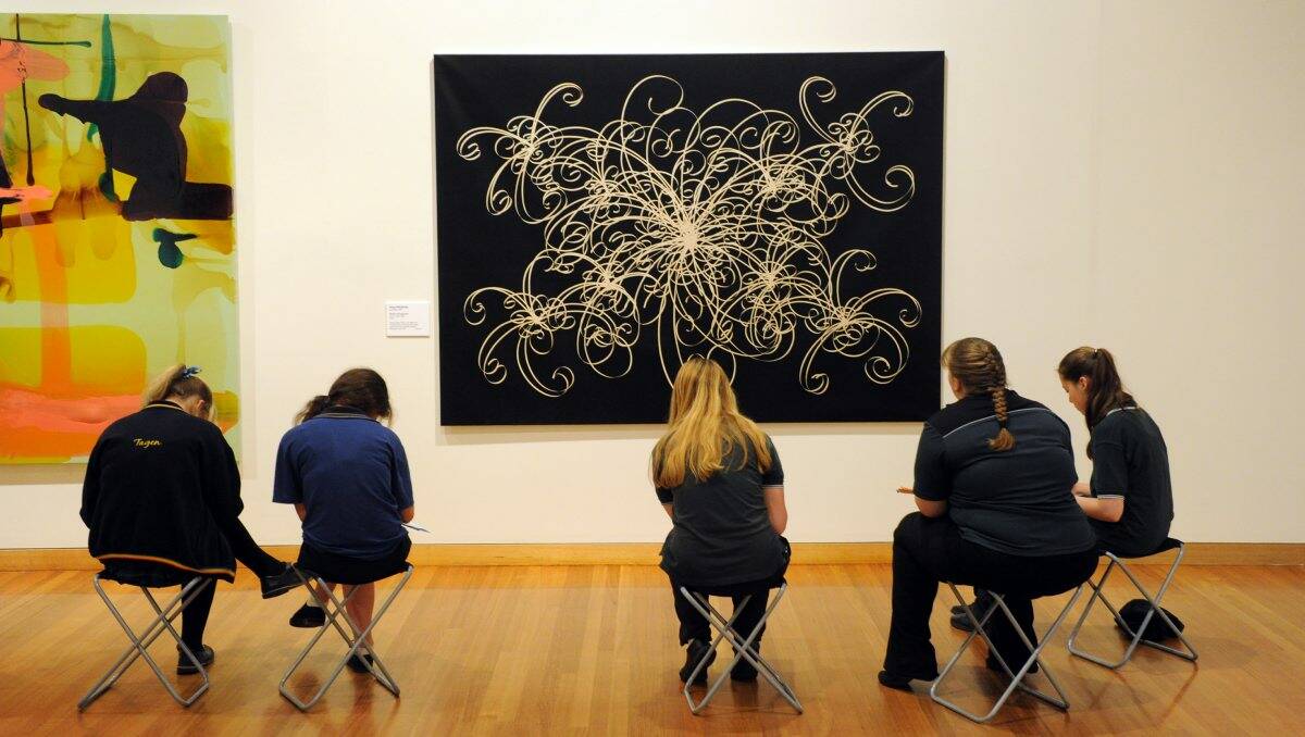 Educational: Students examine pieces at the Bendigo Art Gallery. Picture: Peter Weaving