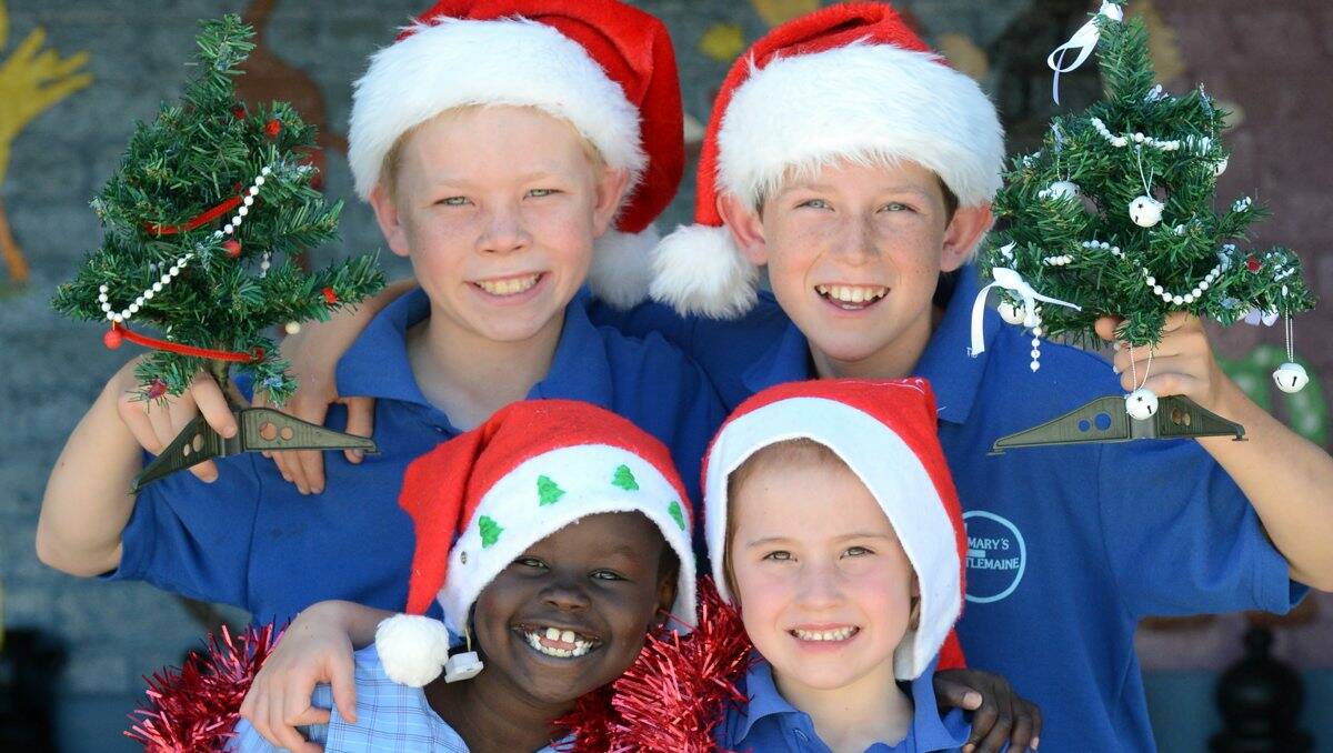 SANTA'S HELPERS: St Mary’s Primary School students, clockwise from front left, Abuk Yai, 7, Austin Williams, 10, Jack Casley, 11, and Bella Trethowan, 6.Picture: JIM ALDERSEY