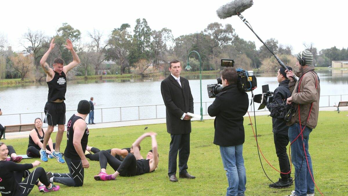  Presenter Mike Dalton broadcasts from Lake Weeroona with Bendigo’s 3T Fitness crew. Picture: Peter Weaving