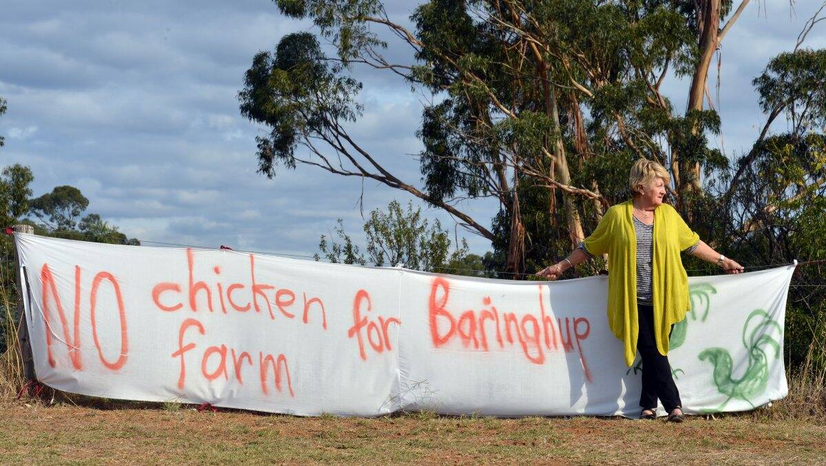 Julia Meere with one of the signs opposing the proposed broiler farm. 