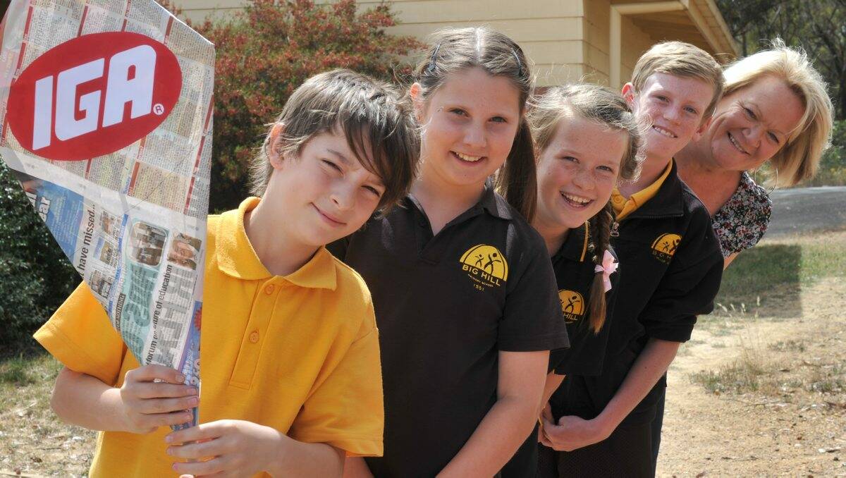 SMILES: Big Hill Primary School students Dallas Ross, Holly Normoyle, Ella Sutton and Ryan O’Keefe with the regional manager of Newspapers in Education, Liz Zelencich. Picture: Jodie Donnellan