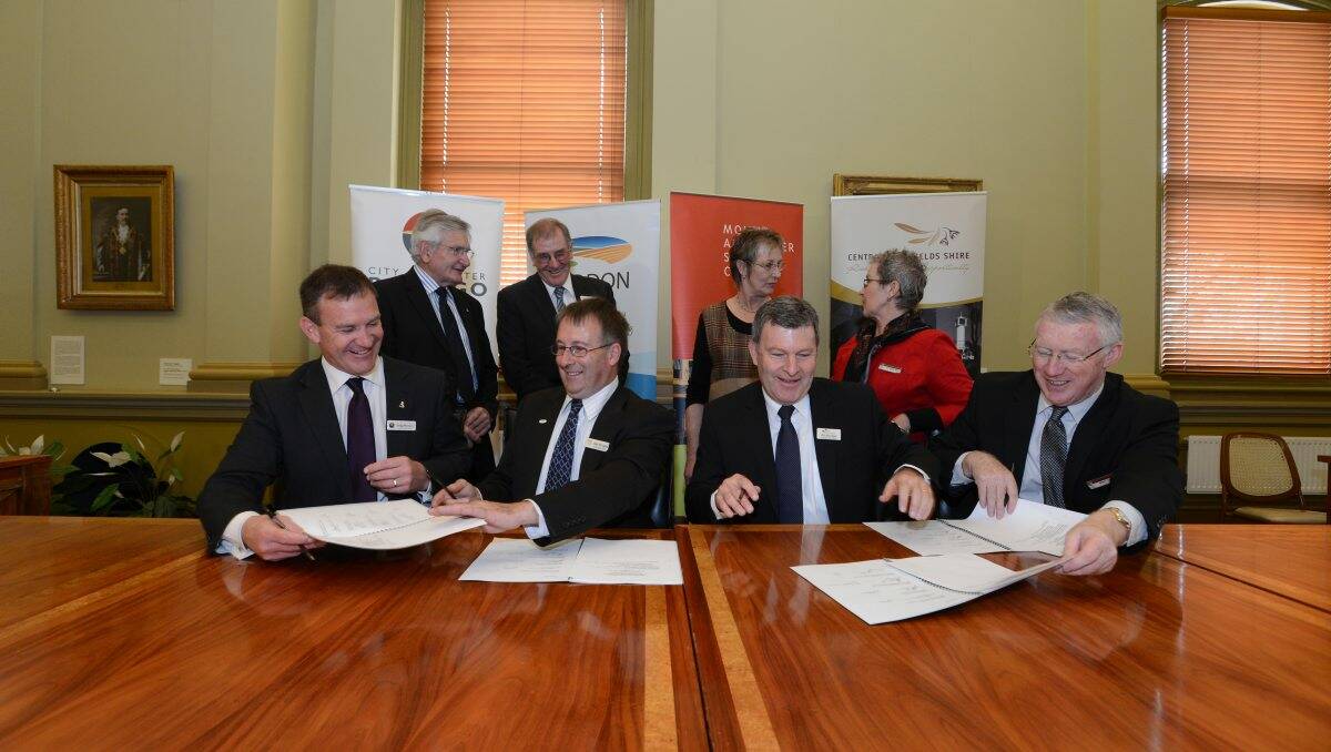 New direction: CoGB Mayor Alec Sandner and CEO Craig Niemann, Loddon Mayor Geoff Curnow and CEO John McClinden, Mt Alexander Mayor Janet Cropley and CEO Phil Rowland with Central Goldfields Mayor Paula Nixon and CEO Mark Johnston signing documents for a new tourism board. Picture: JIM ALDERSEY