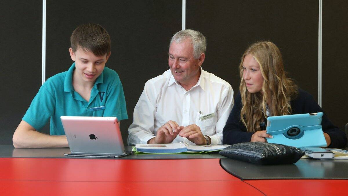 STUDIOUS: Victory Christian College will introduce VCE studies for the first time. Year 11 students and school captains Zak Lovell and Emma Selisky, pictured with head of senior school Phil Britton, are among eight VCE students enrolled this year. Picture: Peter Weaving